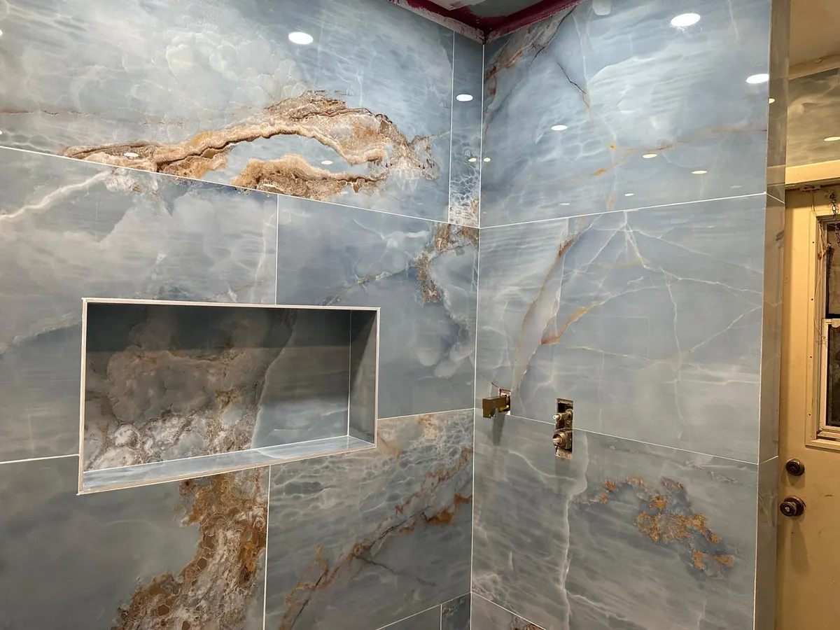 Bathroom shower niche with marbled tile