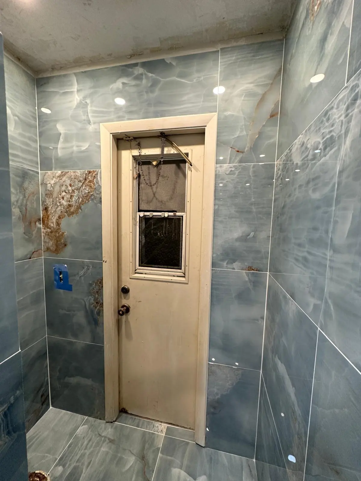 Finished bathroom tile work around the doorway