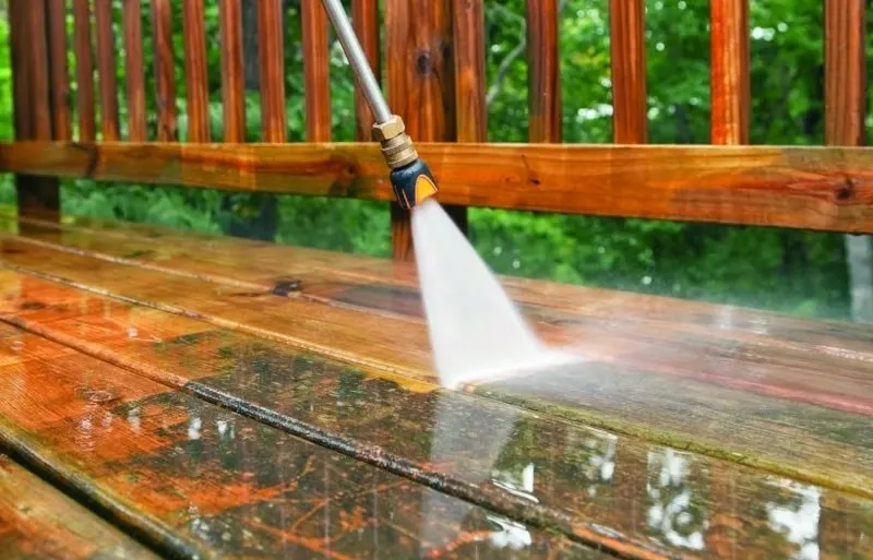 Pressure washing a deck railing and boards